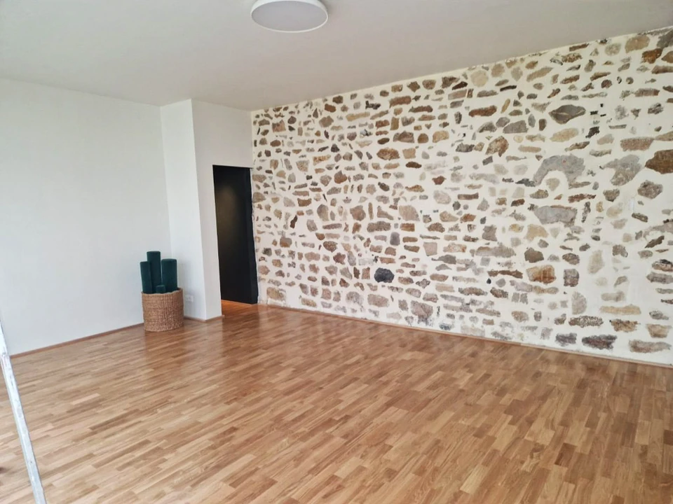 Intérieur vide avec murs blancs tachés d'humidité et parquet en bois